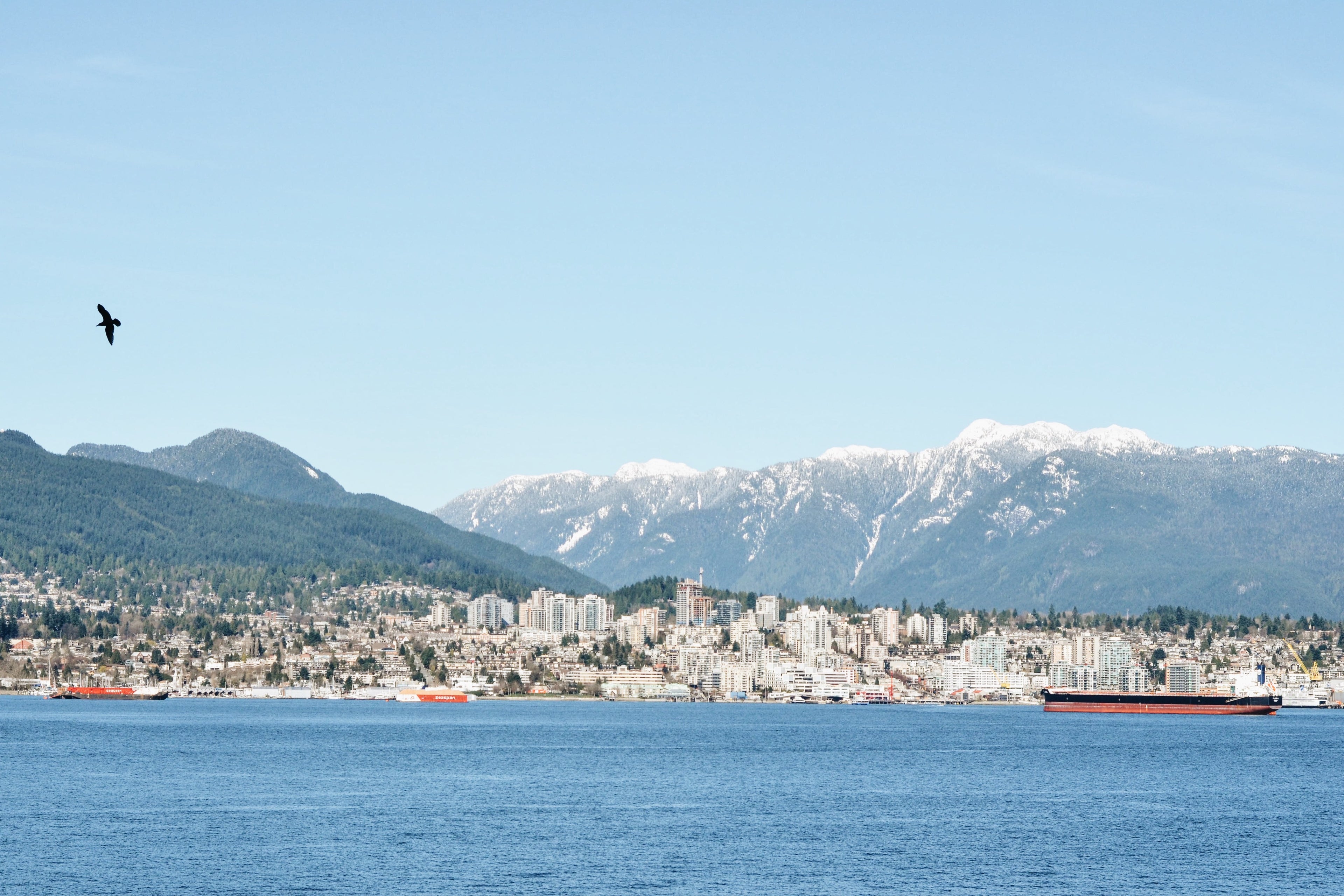 vancouver harbor with mountains by city